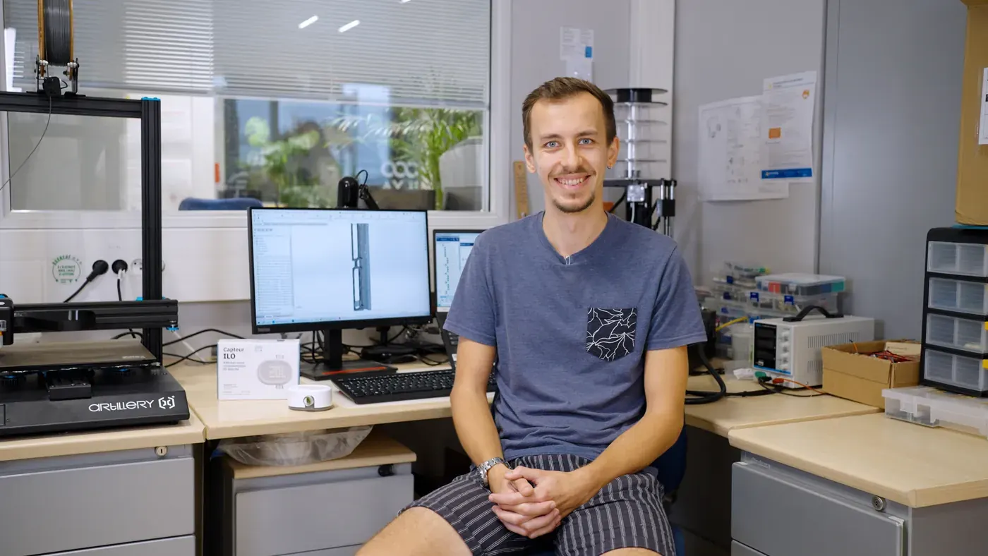 A designer absorbed in FreeCAD, comfortably settled in their home office.